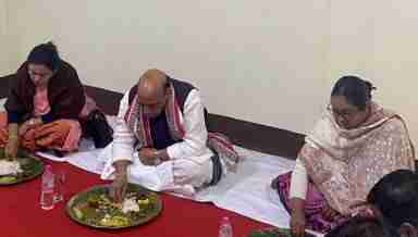 Union Defence Minister Rajnath Singh relishes traditional Manipuri lunch at the residence of Late Yumnam Kalleshor Kom in Imphal (PHOTO: Twitter)