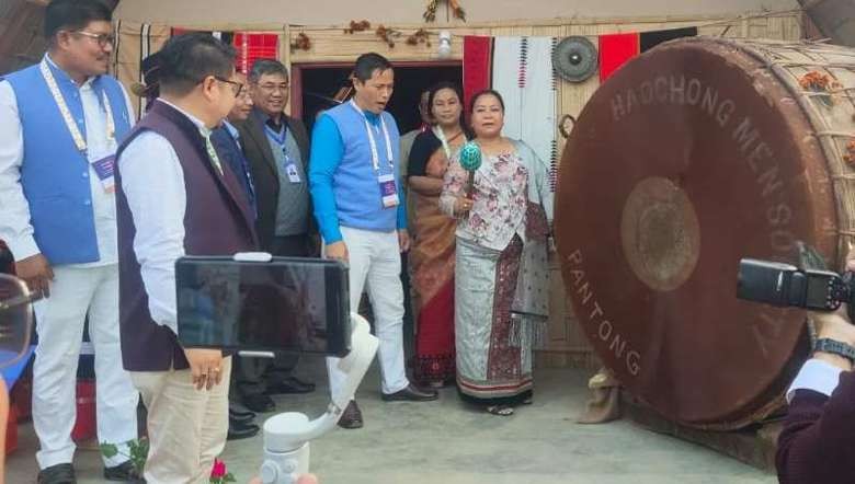 Nemcha Kipgen, Cabinet Minister, Manipur with the log drum displayed at G20, Sangai Ethnic Park, Manipur (Image: Aron Bariamtak)