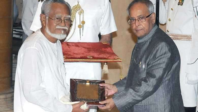 File Photo_Heisnam Kanhailal recieving the Sangeet Natak Akademi Fellowship from Former President Pranab Mukherjee in 2012