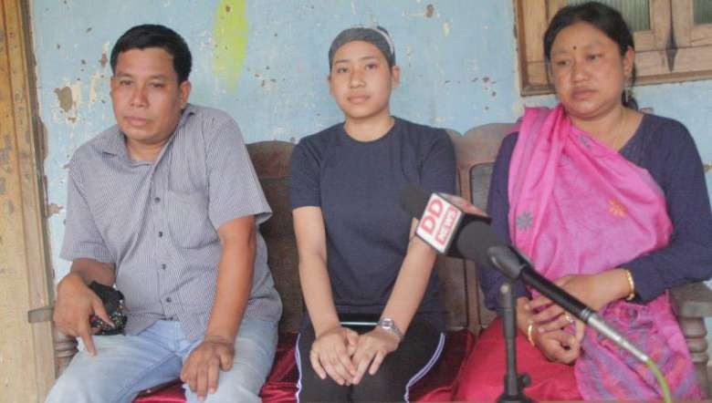 Justina Yendrenbam, Commerce topper in class-12 examination with her parents, July 17,2020 (PHOTO: IFP))