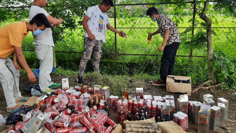 Seized liquor being disposed of in front of AMSU headquarter office, DM College campus (PHOTO: IFP)